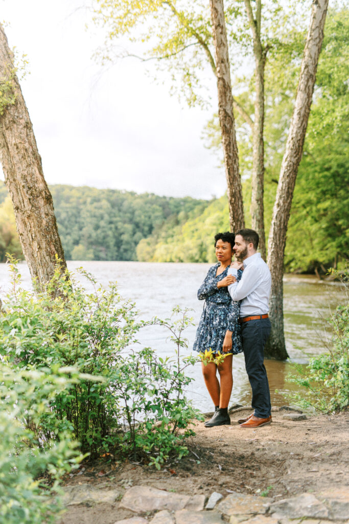 Couple poses together during a Chattahoochee Coffee Company engagement photography session in Atlanta, GA