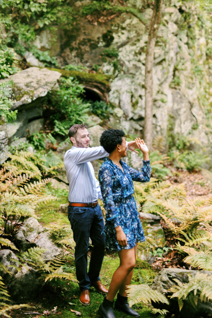 Couple dances among the ferns at Chattahoochee Coffee Company in Atlanta, Georgia during engagement photo session