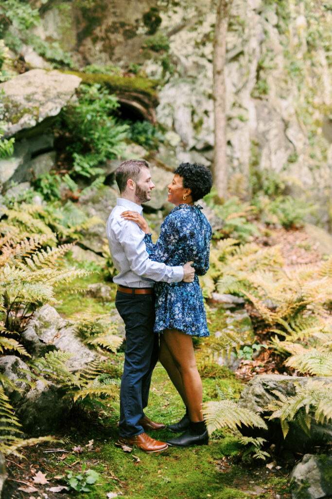 Couple dances among the ferns at Chattahoochee Coffee Company in Atlanta, Georgia during engagement photo session