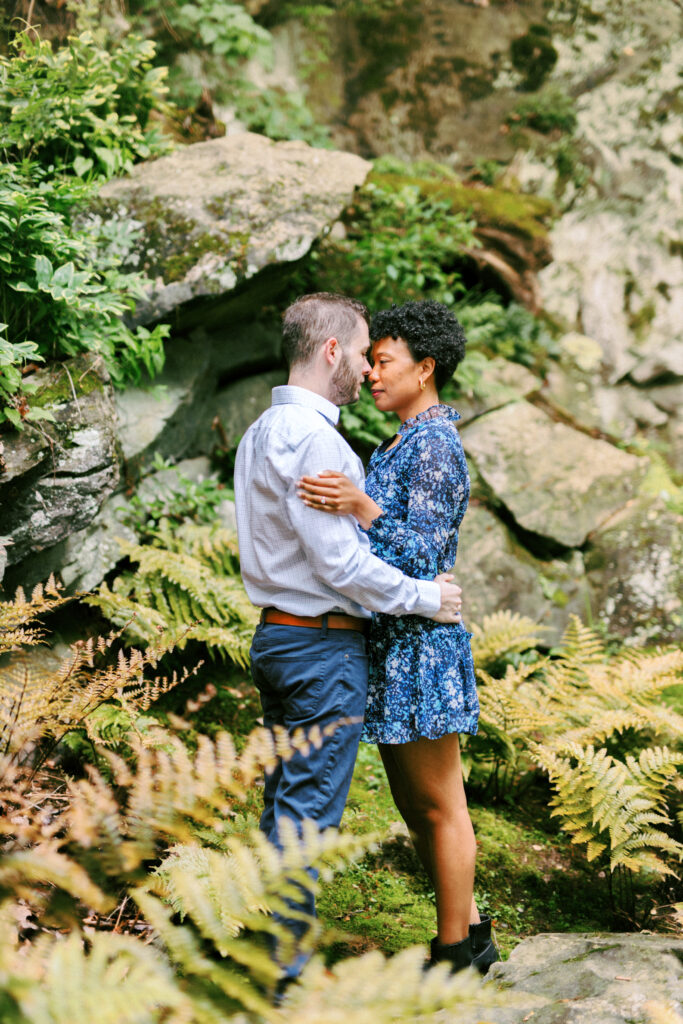 Couple embraces at Chattahoochee Coffee Company in Atlanta, Georgia during engagement photo session