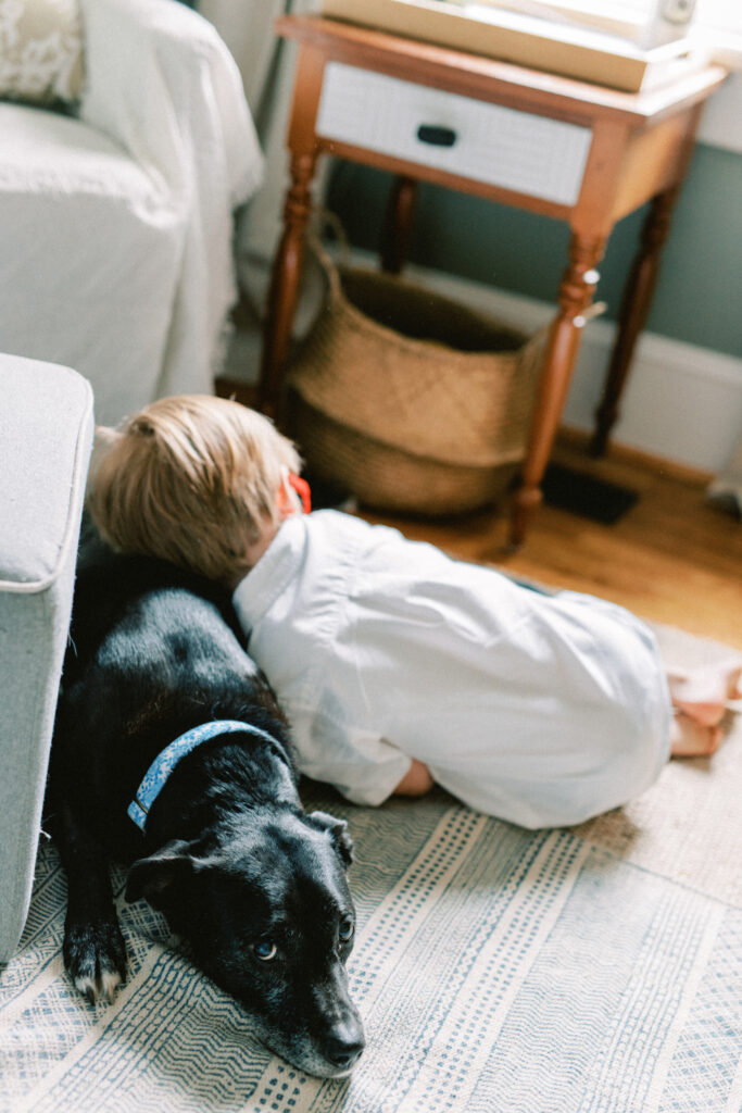 Young boy hugs family dog