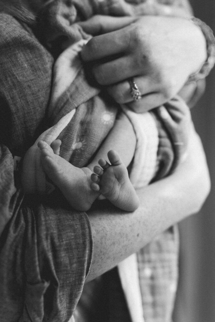 Tiny newborn feet wrapped in blanket