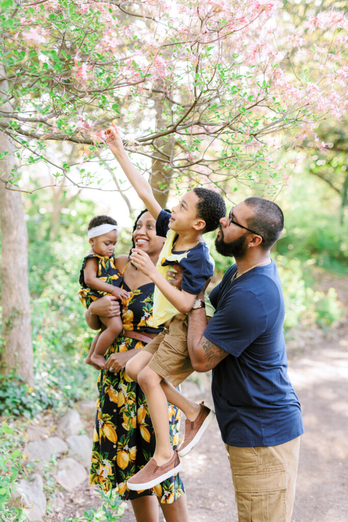 Family of 4 laughs and plays while wearing matching lemon outfits in Piedmont Park, Atlanta