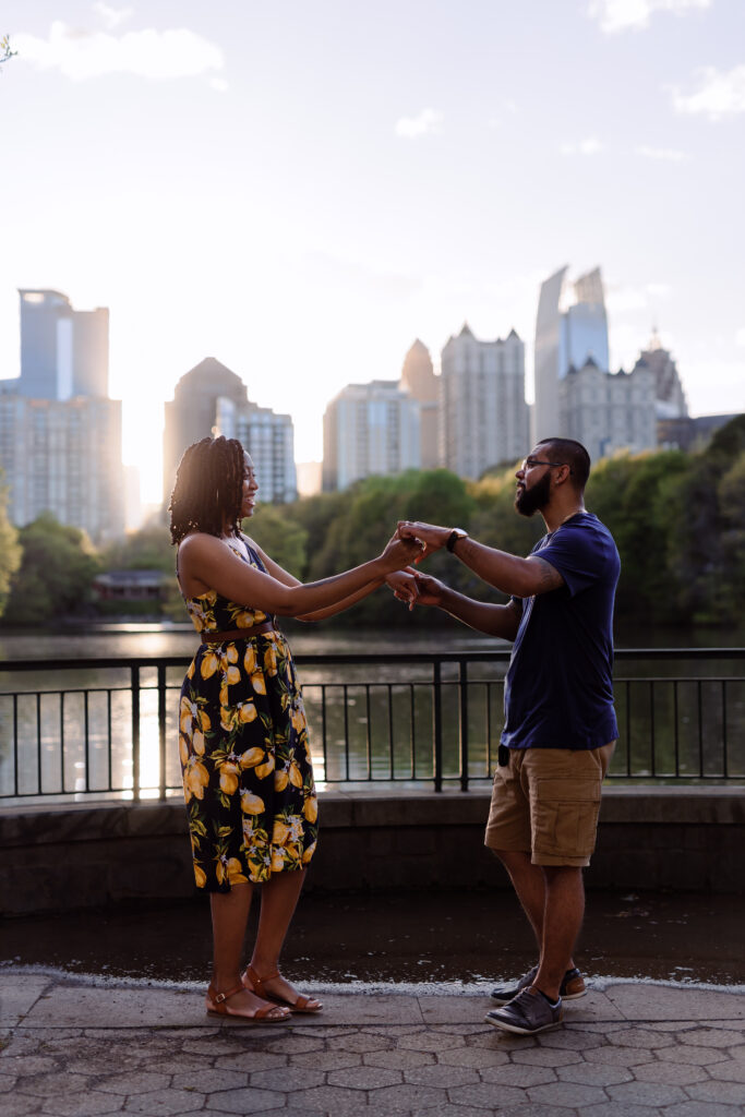 Couple dances at sunset in front of Atlanta Skyline at Piedmont Park