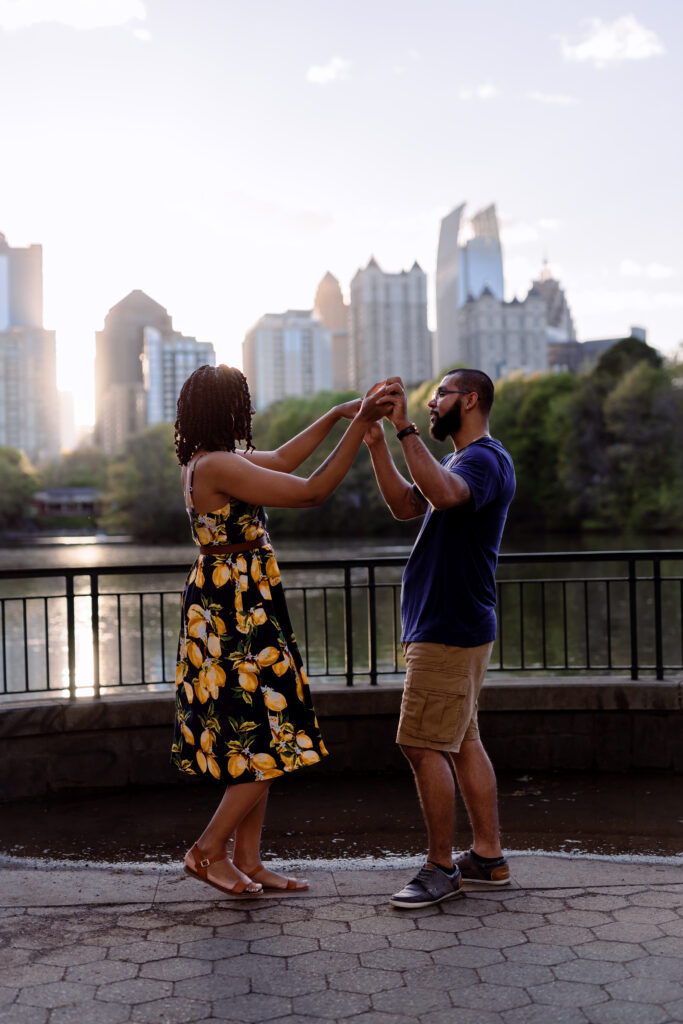 Couple dances at sunset in front of Atlanta Skyline at Piedmont Park