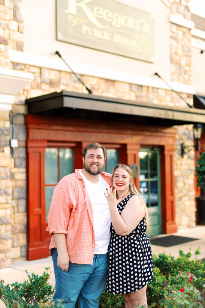 Newly engaged fiance shows off ring after proposal at surprise engagement party Keegan's Public House in Kennesaw, Georgia