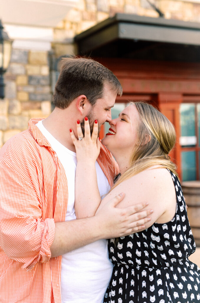 Newly engaged woman has left hand on fiance's face after he proposed to her in Kennesaw, Georgia