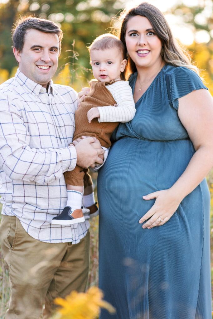 Family smiles together during maternity photoshoot at Green Meadows Preserve