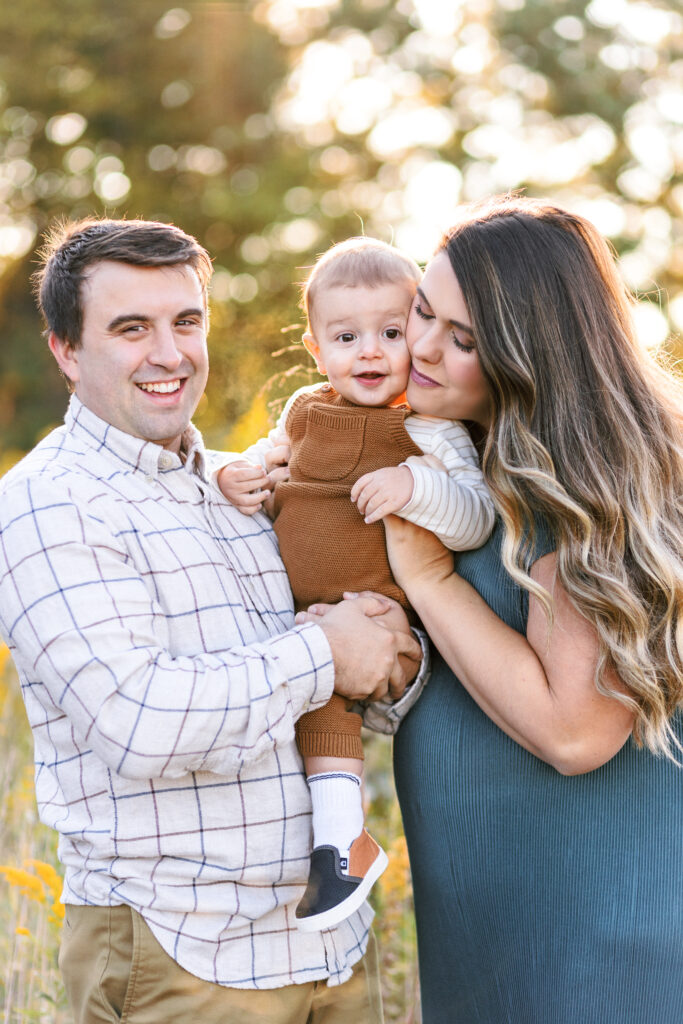 Family shares sweet moment during maternity photoshoot at Green Meadows Preserve