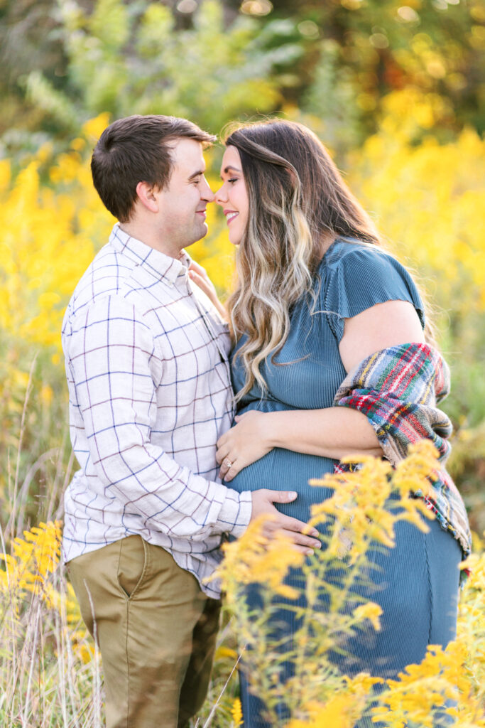 Expecting parents share a moment during maternity photoshoot at Green Meadows Preserve