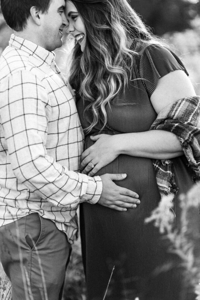 Expecting parents share a moment during maternity photoshoot at Green Meadows Preserve