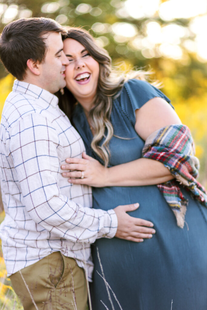 Expecting parents laugh together during maternity photoshoot in Cobb County, Georgia