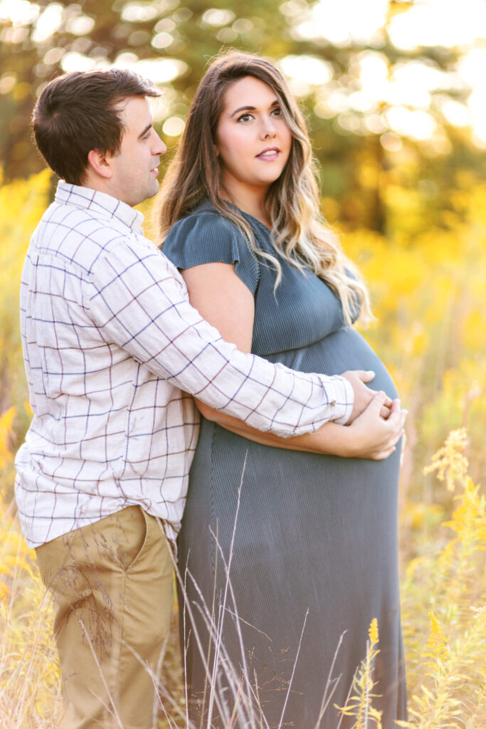 Expecting parents pose during maternity photoshoot at Green Meadows Preserve in Marietta, Georgia