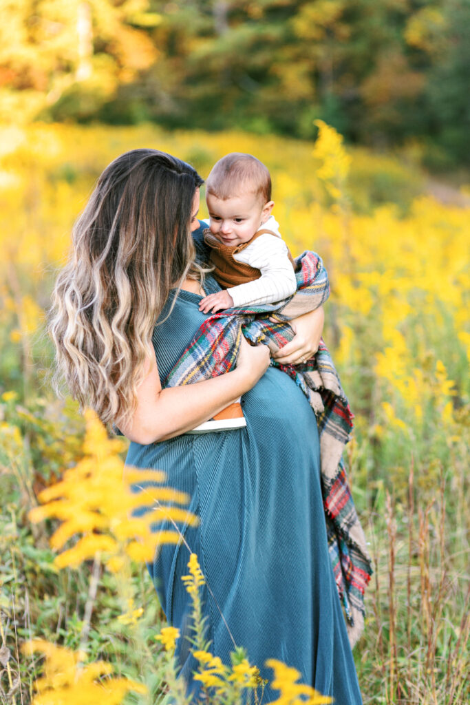 Pregnant mom shares moment with toddler during motherhood photoshoot at Green Meadows Preserve in Marietta, Georgia