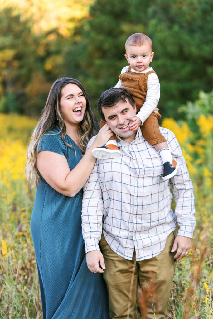 Family laughs during motherhood photoshoot at Green Meadows Preserve in Marietta, Georgia