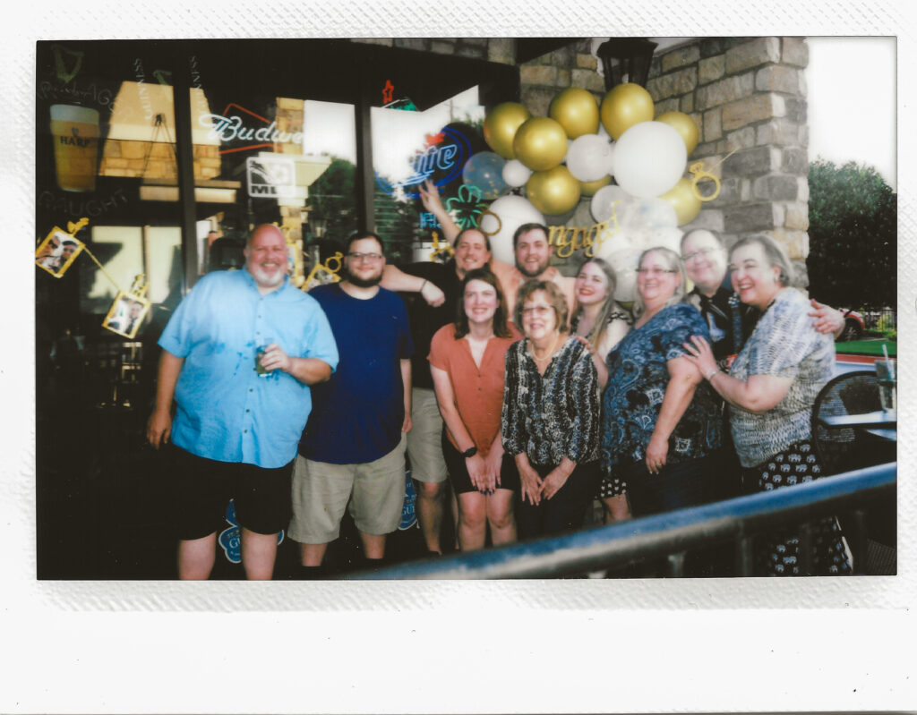 Instant photo, polaroid of couple's family at surprise engagement party at Keegan's Irish Pub in Kennesaw, Georgia